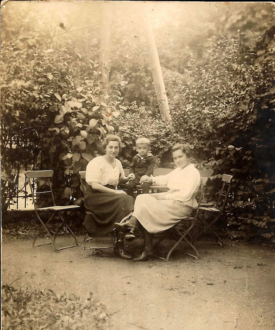 Hans Manneberg siedzący pomiędzy opiekunką Aną (z lewej) a swą siostrą na tyłach kamienicy Mannebergów przy ul. Sobieskiego 15