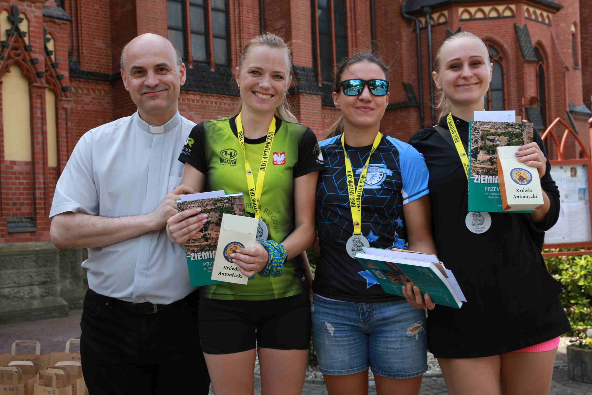 Proboszcz ks. Marek Bernacki i najszybsze biegaczki; od lewej: Maryna Sushko, Judyta Wróblewska i Agnieszka Brejnak. Zdj. Wacław Troszka